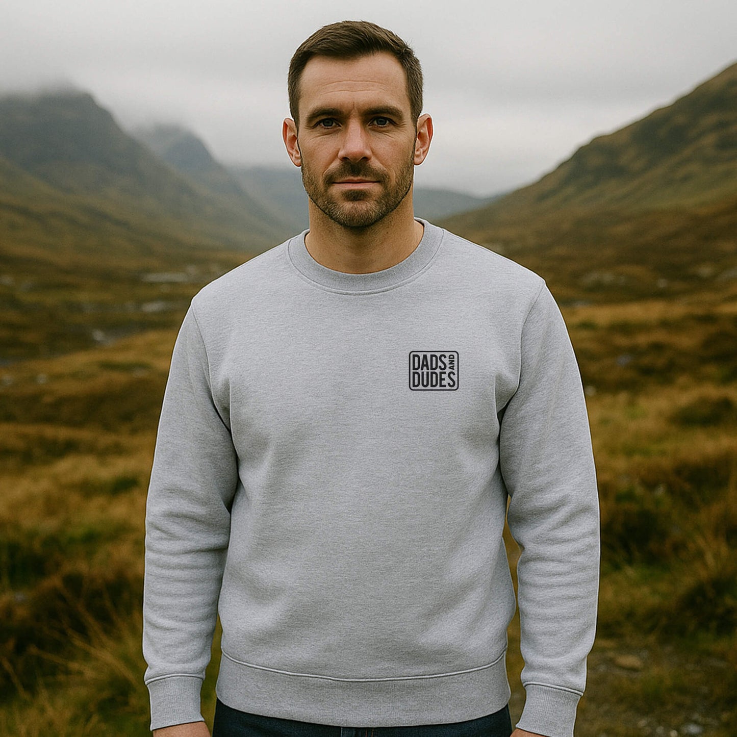 Front view of man wearing a Grey Dads And Dudes Sweatshirt while hiking.