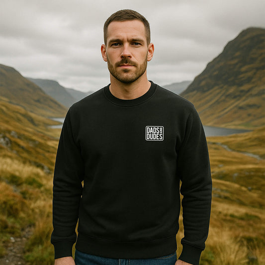 Front view of man wearing a Black Dads And Dudes Sweatshirt while hiking.