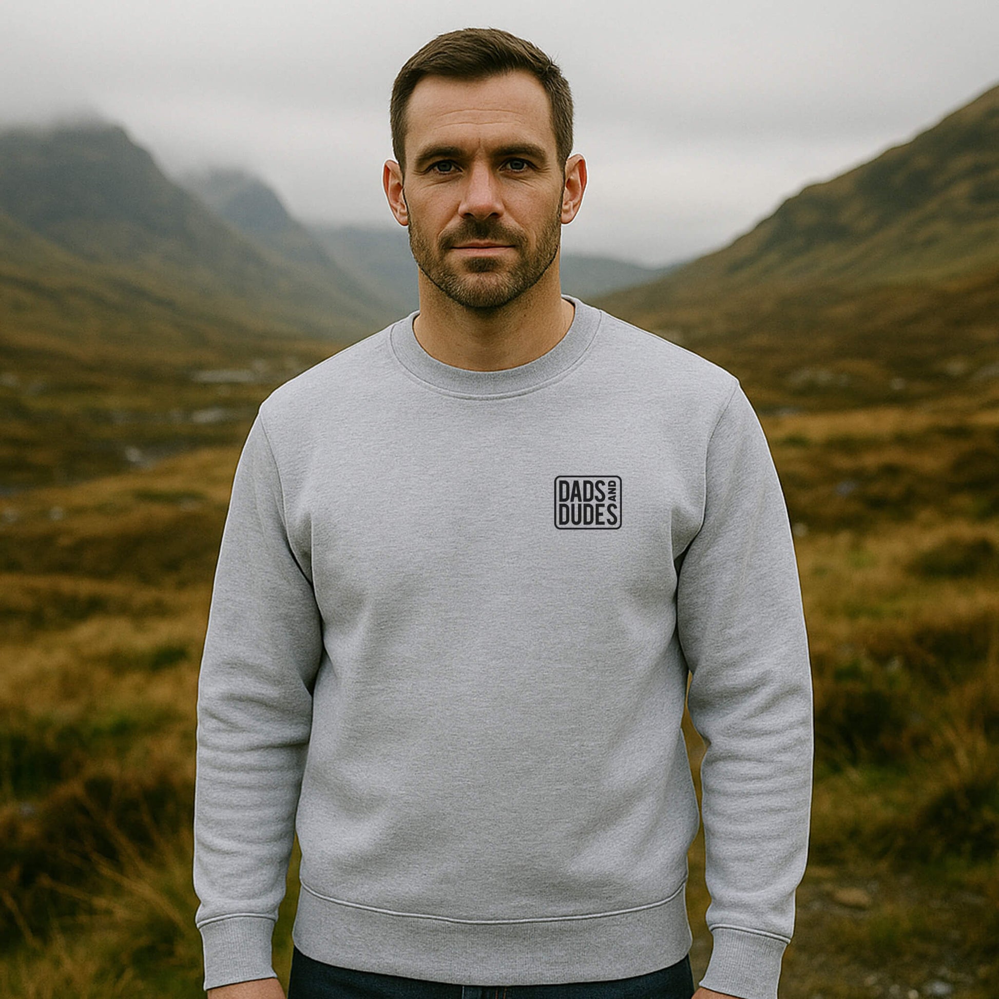 Front view of man wearing a Grey Dads And Dudes Sweatshirt while hiking.