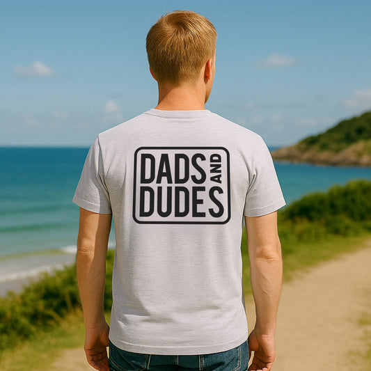 Back view of man wearing a Grey Dads And Dudes Classic T-Shirt on the way to a beach workout.