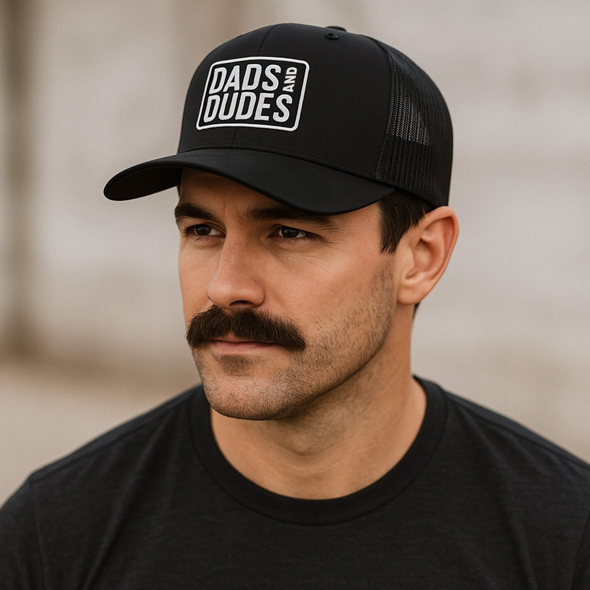 Dads And Dudes Black Embroidered Logo Trucker Cap.