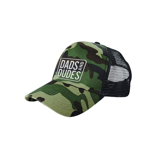 Dads And Dudes Jungle Camo Embroidered Logo Trucker Cap on white background.